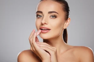 a portrait of a woman touching her lips after lip fillers for wrinkles treatment