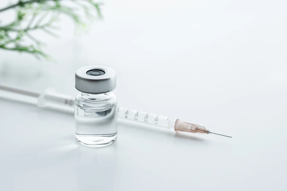 a syringe and a vial of lip filler