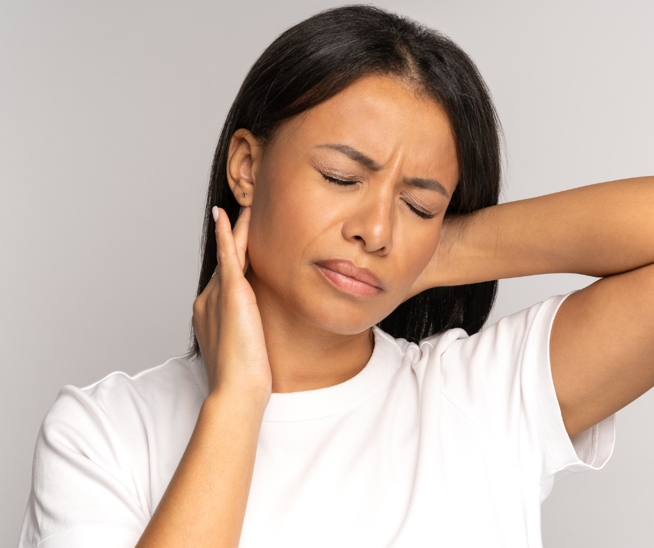 woman experiencing neck pain and touching sore area